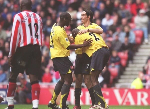 Sol Campbell, Robert Pires and Abu Diaby celebrate the 1st goal