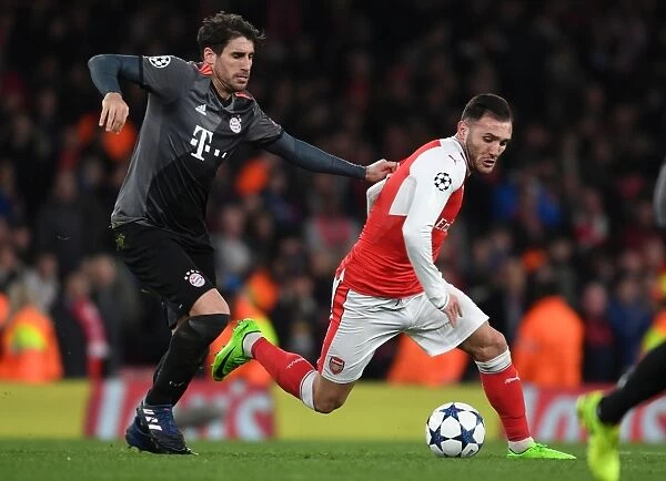 Spanish Showdown: Lucas Perez vs. Javi Martinez in Arsenal FC vs. FC Bayern Munich UEFA Champions League Clash