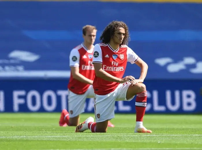 Framed Print : Empty Stands: Matteo Guendouzi Kneels at Brighton & Hove Albion vs Arsenal FC, Premier League 2019-2020