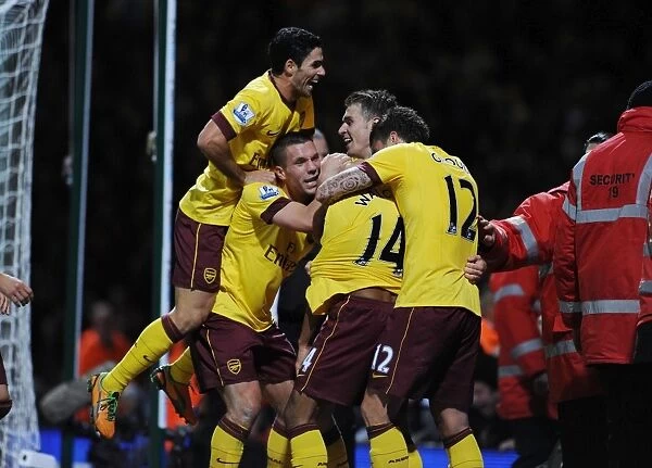 Four Stars: Walcott, Podolski, Ramsey, and Giroud Celebrate Arsenal's Win Against West Ham United (2012-13)