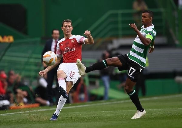 Stephan Lichtsteiner vs. Nani: Battle for Ball Possession in Arsenal's Europa League Clash with Sporting Lisbon