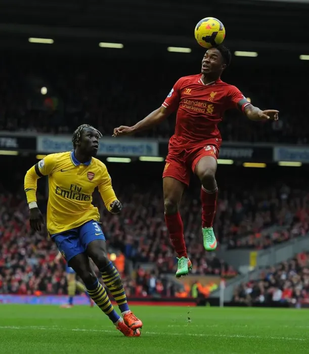 Framed Print : Sterling Soars Past Sagna: Intense Moment from the Liverpool vs. Arsenal Premier League Clash