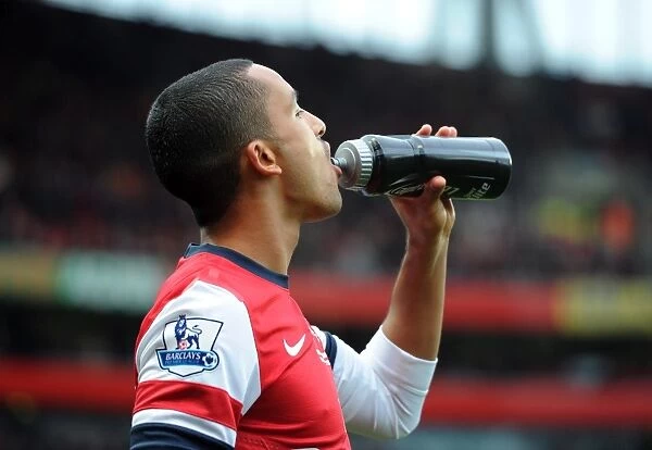 Theo Walcott (Arsenal) with a Lucazade bottle. Arsenal 3:3 Fulham. Barclays Premier League