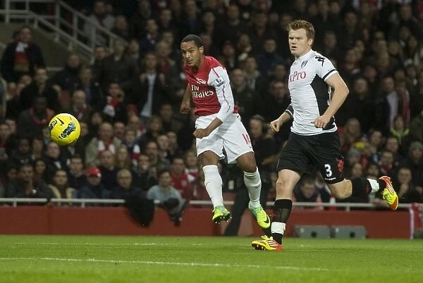 Theo Walcott of Arsenal shoots past John Arne Riise of Fulham during the Barclays Premier League match between Arsenal and Fulham at Emirates Stadium on November 26, 2011 in London, England. Credit