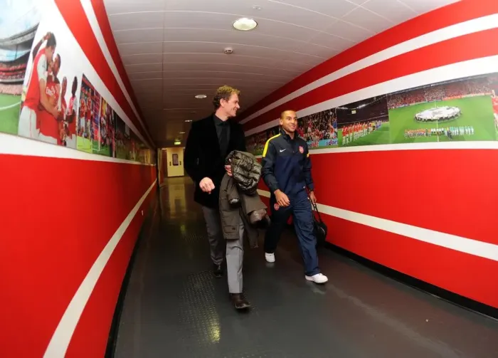 Framed Print : Theo Walcott (Arsenal) walks in with former Arsenal Player Jens Lehmann. Arsenal 1: 3 Bayern Munich