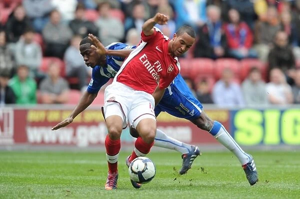 Theo Walcott breaks past Wigan defender Maynor Figueroa to score the 1st Arsenal goal