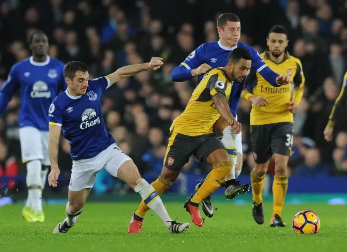 Framed Print : Theo Walcott Clashes with Everton's Leighton Baines and Ross Barkley during the Intense Everton vs Arsenal Premier League Match, 2016-17