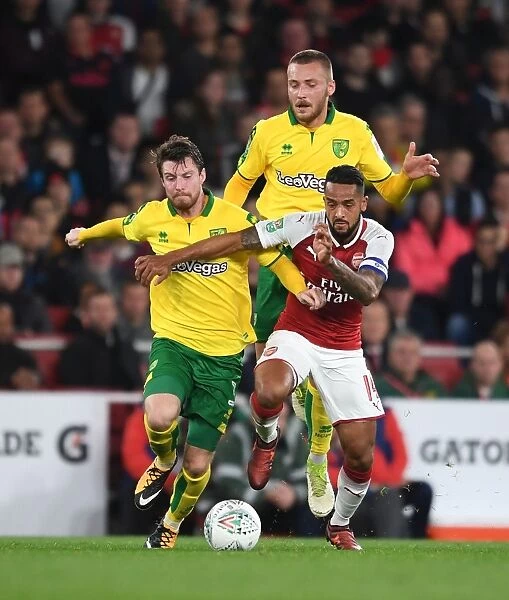 Theo Walcott Clashes with Norwich's James Husband and Tom Trybull during Arsenal's Carabao Cup Fourth Round Match