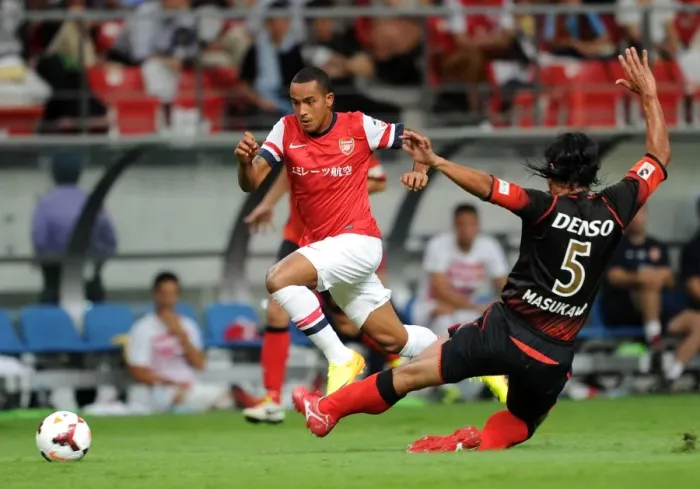 Framed Print : Theo Walcott Outmaneuvers Takahiro Masukawa: Nagoya Grampus vs. Arsenal, 2013