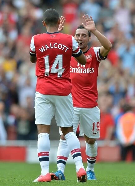 Theo Walcott and Santi Cazorla's Jubilant Moment: Arsenal's 6-1 Thrashing of Southampton in the Premier League