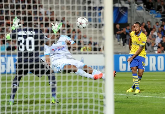 Framed Print : Theo Walcott Scores Against Mandanda: Arsenal Triumphs Over Marseille in Champions League Clash