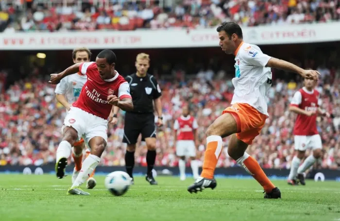 Framed Print : Theo Walcott shoots past Blackpool defender Dekel Keinan to score the 3rd Arsenal goal Framed Print : Theo Walcott shoots past Blackpool defender Dekel Keinan to score the 3rd Arsenal goal