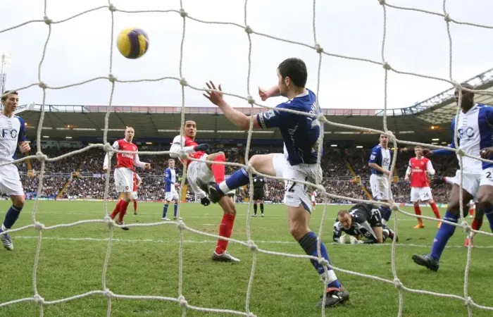 Framed Print : Theo Walcott shoots past Damien Johnson to score the 1st Arsenal goal Framed Print : Theo Walcott shoots past Damien Johnson to score the 1st Arsenal goal