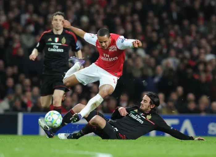 Framed Print : Theo Walcott vs Alberto Aquilani: Intense Battle in Arsenal FC vs AC Milan UEFA Champions League Clash Framed Print : Theo Walcott vs Alberto Aquilani: Intense Battle in Arsenal FC vs AC Milan UEFA Champions League Clash