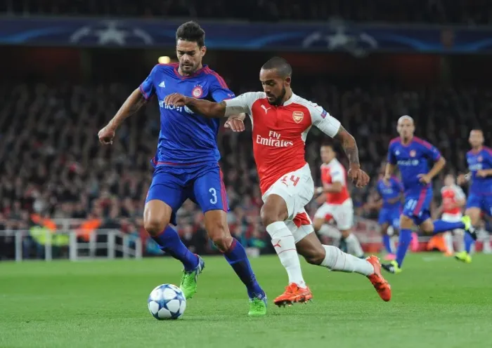 Framed Print : Theo Walcott vs. Alberto Botia: A Fierce Battle in Arsenal's 2015 Champions League Clash