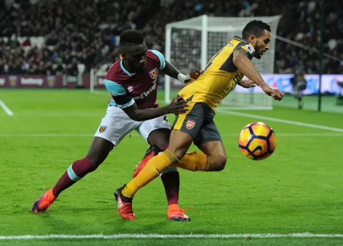 Framed Print : Theo Walcott vs. Arthur Masuaku: A Premier League Rivalry Ignites at London Stadium (2016-17)