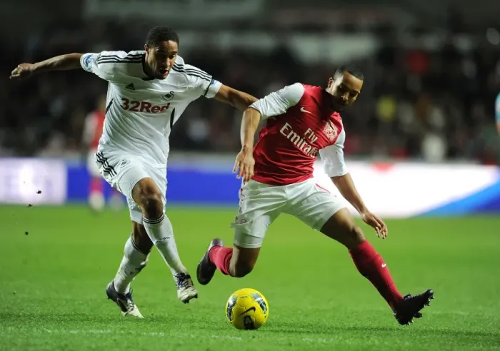 Framed Print : Theo Walcott vs Ashley Williams: A Football Rivalry Erupts at Swansea City (2011-12)