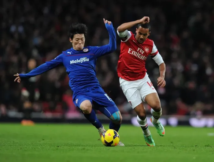 Framed Print : Theo Walcott vs. Bo-Kyung Kim: Intense Clash at Arsenal vs. Cardiff (Premier League, 2013-14) Framed Print : Theo Walcott vs. Bo-Kyung Kim: Intense Clash at Arsenal vs. Cardiff (Premier League, 2013-14)