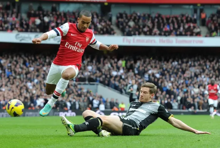 Framed Print : Theo Walcott vs Jan Vertonghen: Intense Battle in the Arsenal v Tottenham Rivalry