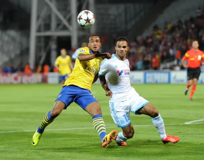 Framed Print : Theo Walcott vs. Jeremy Morel: A Champions League Showdown at Stade Velodrome Framed Print : Theo Walcott vs. Jeremy Morel: A Champions League Showdown at Stade Velodrome