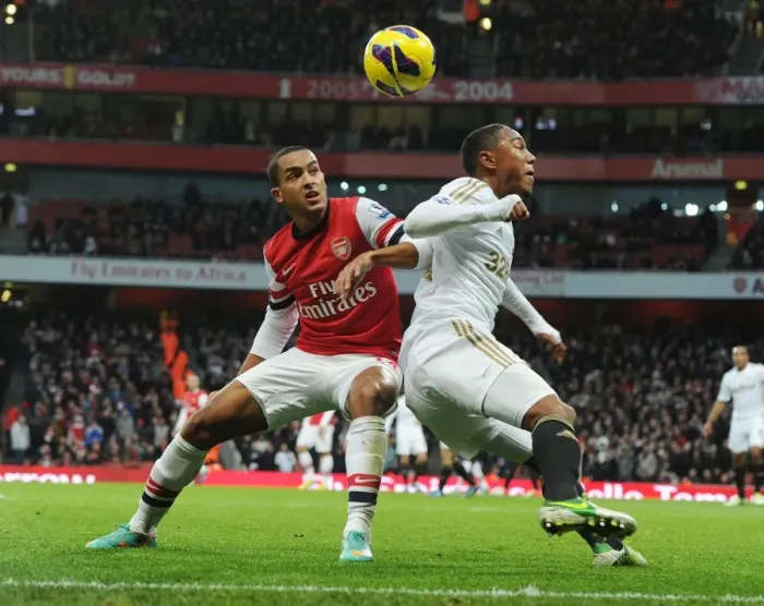 Framed Print : Theo Walcott vs. Jonathan De Guzman: Intense Battle at Arsenal v Swansea (2012-13) Framed Print : Theo Walcott vs. Jonathan De Guzman: Intense Battle at Arsenal v Swansea (2012-13)