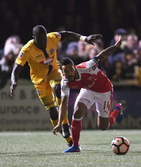 Framed Print : Theo Walcott vs. Kevin Amankwaah: A FA Cup Battle at Sutton United