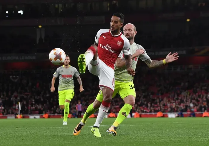 Framed Print : Theo Walcott vs. Konstantin Rausch: A Battle for Control in Arsenal v FC Köln UEFA Europa League Clash Framed Print : Theo Walcott vs. Konstantin Rausch: A Battle for Control in Arsenal v FC Köln UEFA Europa League Clash