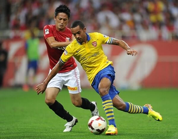 Theo Walcott vs. Kunimitsu Sekiguchi: A Battle for Ball Possession in Arsenal's Pre-Season Clash (2013)