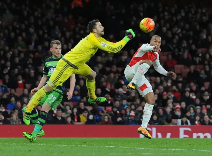 Framed Print : Theo Walcott vs. Lukasz Fabianski: A Premier League Showdown at Arsenal's Emirates Stadium
