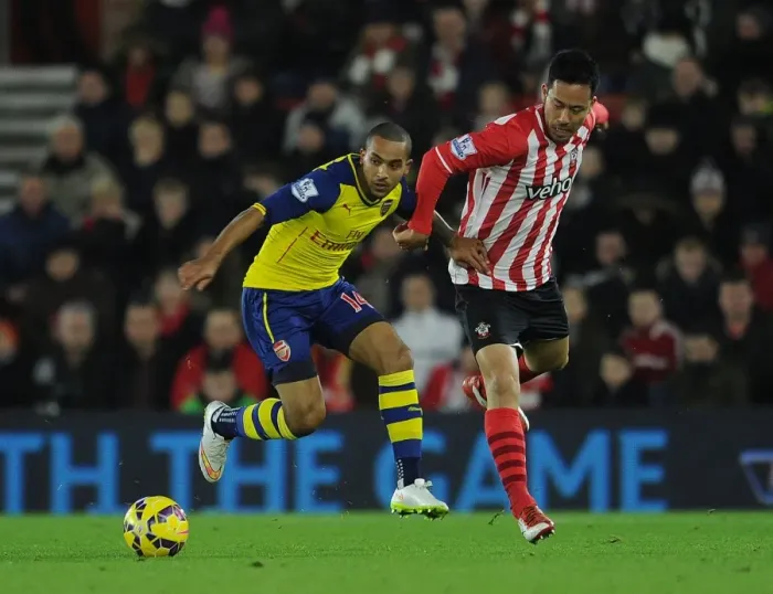 Framed Print : Theo Walcott vs Maya Yoshida: A Battle in the Southampton vs Arsenal Premier League Clash (January 2015)