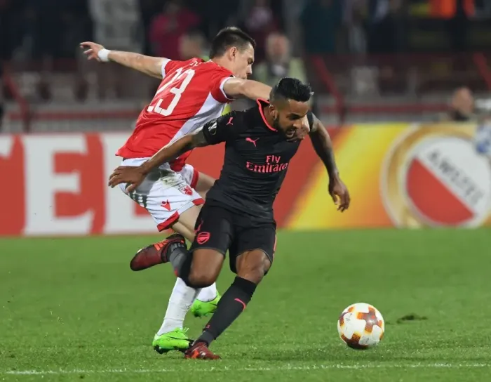 Framed Print : Theo Walcott vs Milan Rodic: A Battle in the Europa League between Crvena Zvezda and Arsenal FC