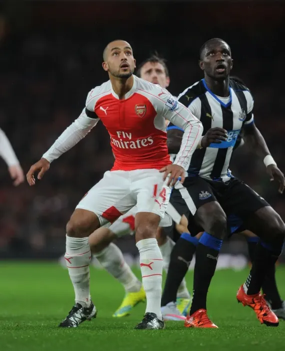 Framed Print : Theo Walcott vs. Moussa Sissoko: A Premier League Showdown at Arsenal vs. Newcastle United