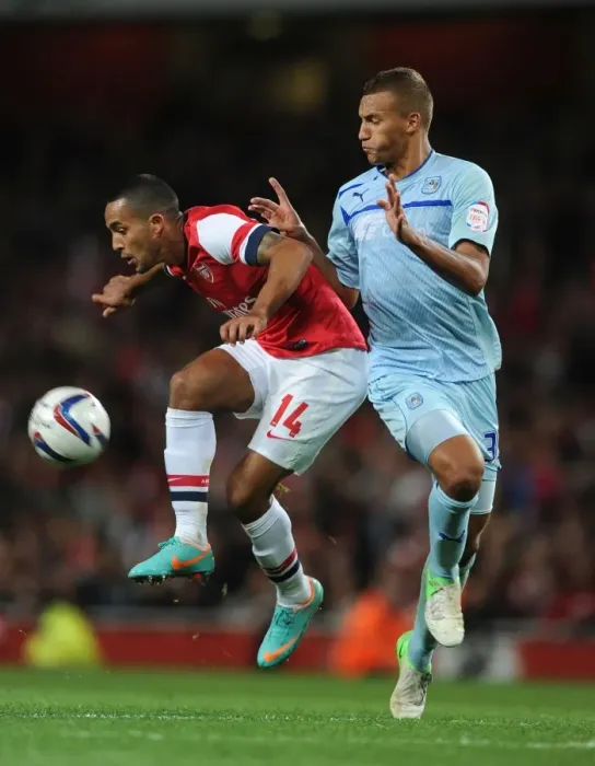 Framed Print : Theo Walcott vs Reece Brown: Arsenal vs Coventry City - Capital One Cup Clash