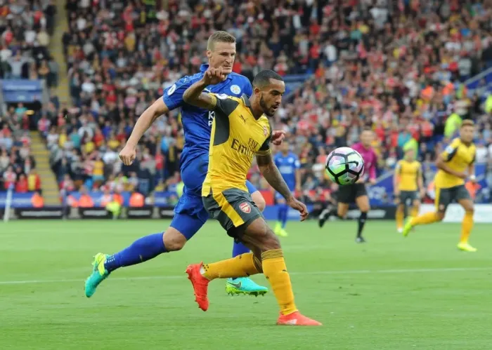 Framed Print : Theo Walcott vs. Robert Huth: A Footballing Battle at The King Power Stadium (2016-17)