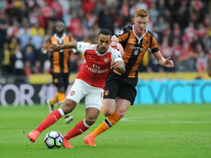 Framed Print : Theo Walcott vs. Sam Clucas: A Premier League Battle at KCOM Stadium