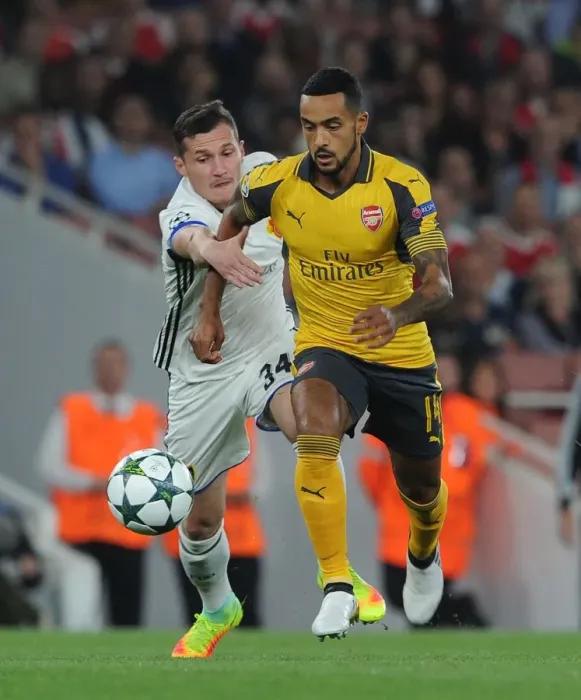 Framed Print : Theo Walcott vs. Taulant Xhaka: A Battle in the Arsenal FC vs. FC Basel UEFA Champions League Clash