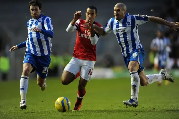 Framed Print : Theo Walcott vs. Wayne Bridge and Adam El-Abd: A Tense FA Cup Showdown - Arsenal's Star Forward Clashes with Brighton's Defenders Framed Print : Theo Walcott vs. Wayne Bridge and Adam El-Abd: A Tense FA Cup Showdown - Arsenal's Star Forward Clashes with Brighton's Defenders