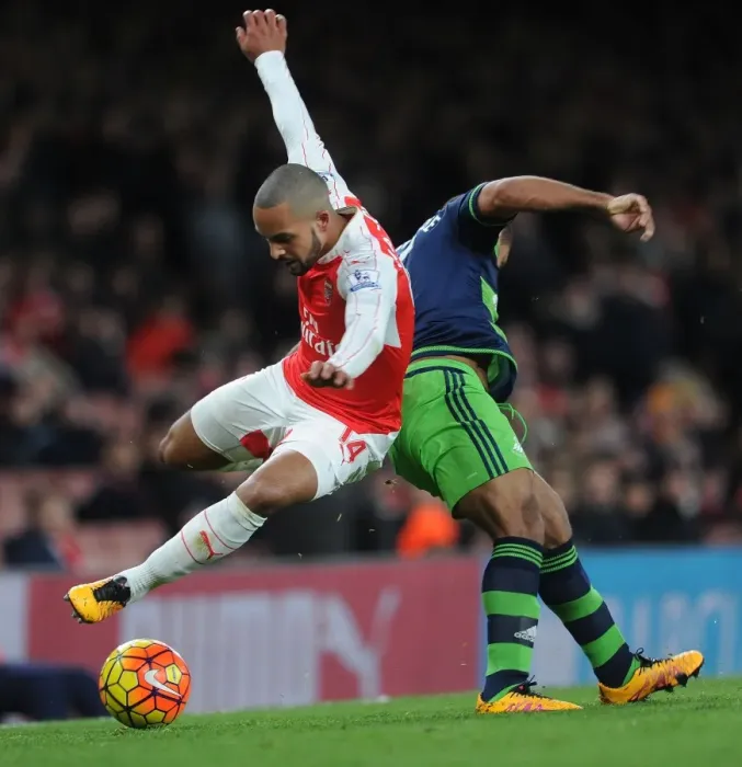 Framed Print : Theo Walcott vs Wayne Routledge: A Premier League Battle at Emirates Stadium Framed Print : Theo Walcott vs Wayne Routledge: A Premier League Battle at Emirates Stadium