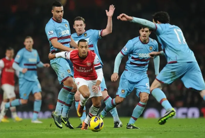 Framed Print : Theo Walcott vs. The West Ham United Defenders: A Battle at the Emirates