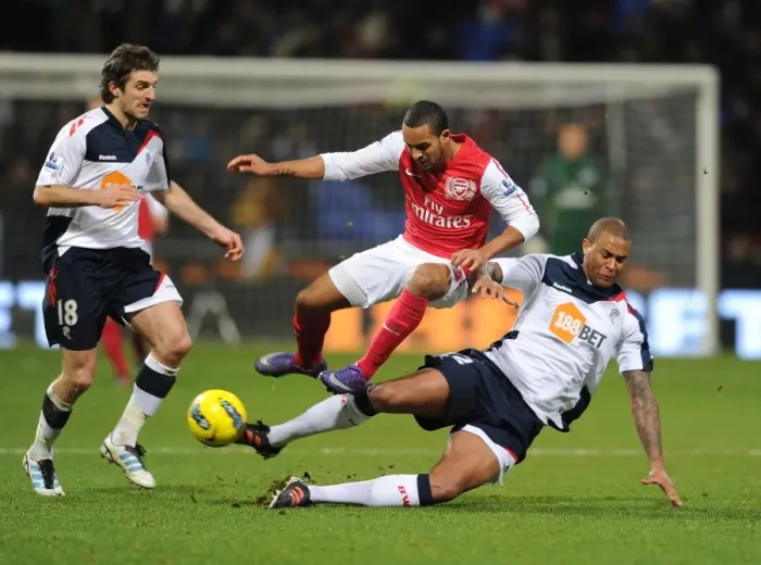 Framed Print : Theo Walcott vs Zat Knight: Intense Battle at Bolton Wanderers vs Arsenal (2011-12)
