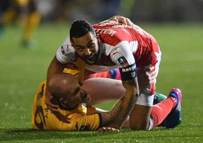 Framed Print : Theo Walcott's Dramatic Fall: Sutton United vs. Arsenal in The Emirates FA Cup