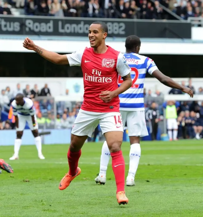 Framed Print : Theo Walcott's Euphoric Goal Celebration: Arsenal's Triumph at Queens Park Rangers, Premier League 2011-12