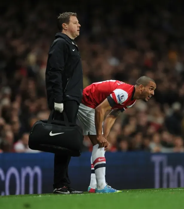 Framed Print : Theo Walcott's Injury: Colin Lewin Tends to Arsenal Star during Arsenal v Everton Match (2012-13)
