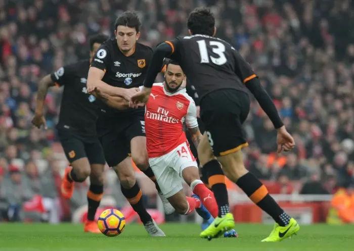 Framed Print : Theo Walcott's Intense Showdown Against Hull City's Defense in the Premier League Framed Print : Theo Walcott's Intense Showdown Against Hull City's Defense in the Premier League
