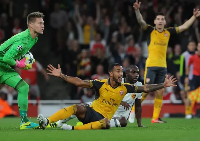 Framed Print : Theo Walcott's Penalty Plea: Arsenal's Battle for a Decisive Spot Kick vs. FC Basel Framed Print : Theo Walcott's Penalty Plea: Arsenal's Battle for a Decisive Spot Kick vs. FC Basel