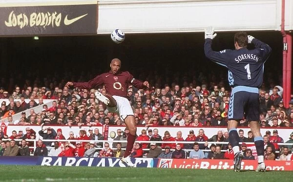 Thierry Henry scores his 1st, Arsenals 2nd goal under pressure from Thomas Sorensen