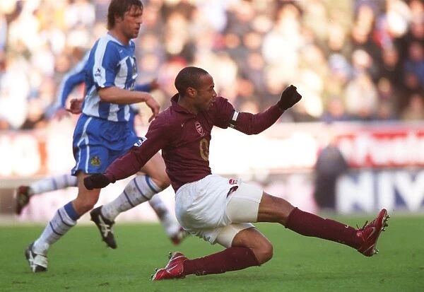 Thierry Henry shoots past Wigan goalkeeper John Filan to score the 2nd Arsenal goal