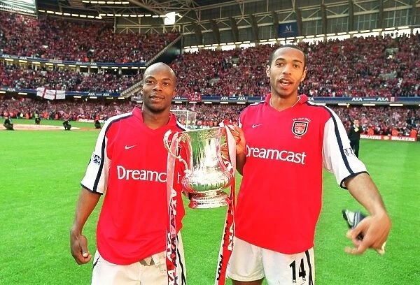 Thierry Henry and Sylvain Wiltord celebrate the Arsenal victory
