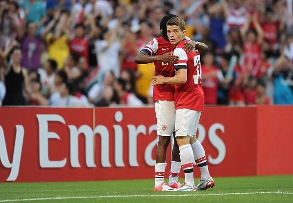 Thomas Eisfeld and Gervinho Celebrate Arsenal's Goals Against Kitchee FC (2012)