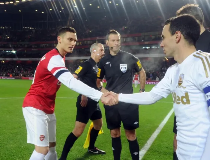 Framed Print : Thomas Vermaelen (Arsenal) Leon Britton (Swansea) with the officials. Arsenal 1: 0 Swansea City Framed Print : Thomas Vermaelen (Arsenal) Leon Britton (Swansea) with the officials. Arsenal 1: 0 Swansea City